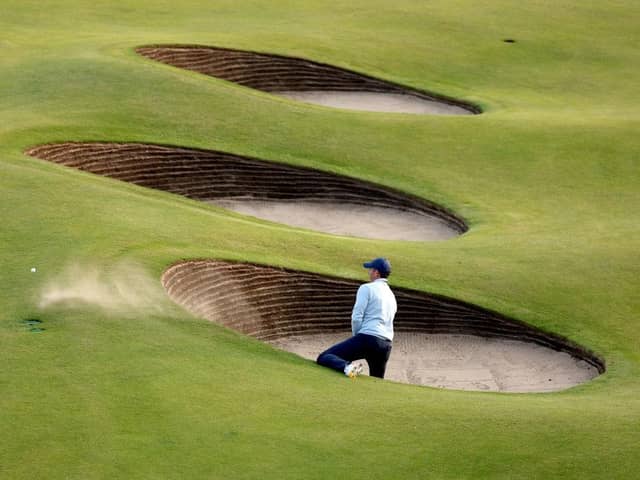Rory McIlroy needed two attempts to escape from a greenside bunker at the 18th in his opening round in the 151st Open at Royal Liverpool. Picture: Warren Little/Getty Images.