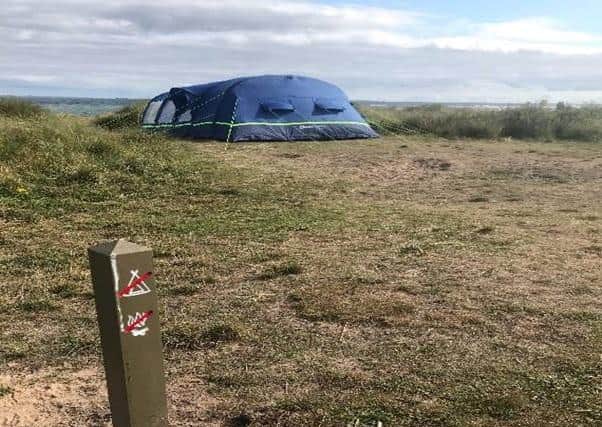 A sign of the times: Campers ignore post telling them 'no camping'.