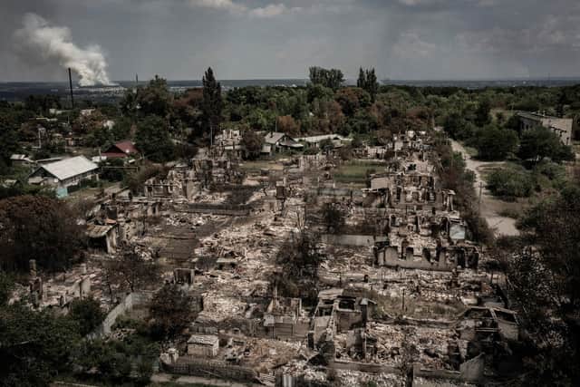 An aerial view shows destroyed houses after strike in the town of Pryvillya at the eastern Ukrainian region of Donbas on June 14, 2022, amid Russian invasion of Ukraine. - The cities of Sievierodonetsk and Lysychansk, which are separated by a river, have been targeted for weeks as the last areas still under Ukrainian control in the eastern Lugansk region. (Photo by ARIS MESSINIS / AFP)