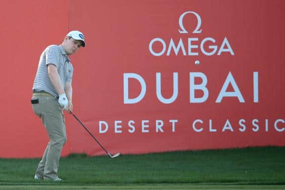 Bob Macintyre chips at the last to set up closing birdie in his opening five-under-par 67. Picture: Andrew Redington/Getty Images.