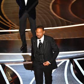 US actor Will Smith (R) walks away after slaping US actor Chris Rock onstage during the 94th Oscars at the Dolby Theatre in Hollywood, California on March 27, 2022. (Photo by Robyn Beck / AFP) (Photo by ROBYN BECK/AFP via Getty Images)