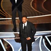 US actor Will Smith (R) walks away after slaping US actor Chris Rock onstage during the 94th Oscars at the Dolby Theatre in Hollywood, California on March 27, 2022. (Photo by Robyn Beck / AFP) (Photo by ROBYN BECK/AFP via Getty Images)