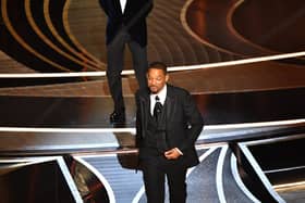 US actor Will Smith (R) walks away after slaping US actor Chris Rock onstage during the 94th Oscars at the Dolby Theatre in Hollywood, California on March 27, 2022. (Photo by Robyn Beck / AFP) (Photo by ROBYN BECK/AFP via Getty Images)