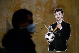 Grafitti entitled 'Il Golpe Fallito', the 'failed coup', by Italian artist Laika, showing Juventus president Andrea Agnelli, an architect of the European Super League plan, puncturing a football, near the headquarters of the Italian Football Federation in Rome (Picture: Filippo Monteforte/AFP via Getty Images)
