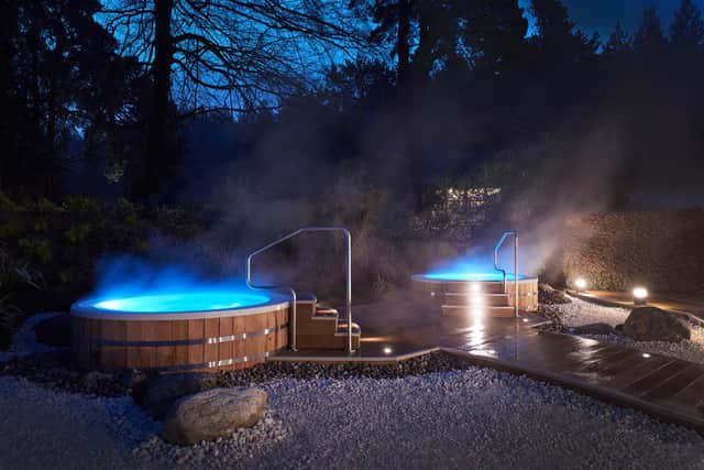 The spa's outdoor hot tubs at Center Parcs,  Longleat Forest, Wiltshire.