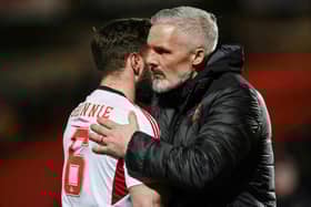 Dundee United manager Jim Goodwin and Aberdeen's Graeme Shinnie embrace after the match at Tannadice.