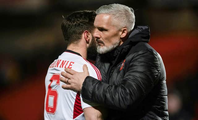 Dundee United manager Jim Goodwin and Aberdeen's Graeme Shinnie embrace after the match at Tannadice.