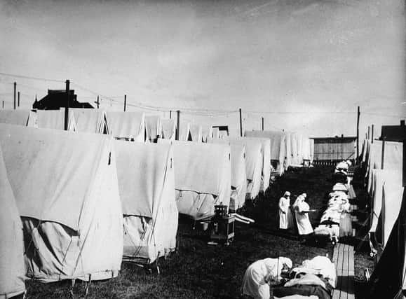 Nurses care for victims of a Spanish influenza epidemic in a field hospital of canvas tents. One soldier, in his account of the pandemic, wondered whether a war-weary God had sent a plague to finish off mankind, such was his horror of the new devastation that surrounded him.
