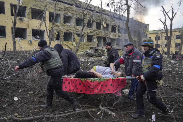 Iryna Kalinina, 32, an injured pregnant woman, is carried from a maternity hospital that was damaged during a Russian airstrike in Mariupol, Ukraine, on 9 March 2022. Associated Press photographer Evgeniy Maloletka won the World Press Photo of the Year award on Thursday, April 20, 2023, for this harrowing image of emergency workers carrying a pregnant woman through the shattered grounds of a maternity hospital in the Ukrainian city of Mariupol in the chaotic aftermath of a Russian attack. (AP Photo/Evgeniy Maloletka, File)