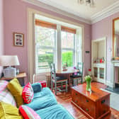 Plenty of period features enhance the flat’s bright living room