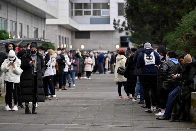 Members of the public queue for vaccinations on a vaccination bus at West College Scotland Clydebank Campus on December 17, 2021 in Glasgow. (Image credit: Jeff J Mitchell/Getty Images)