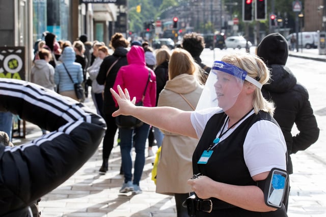 Members of staff at Primark on Princes Street in Edinburgh, welcome customers after the store reopened today as part of Scotland's phased plan to ease out of the coronavirus pandemic lockdown.