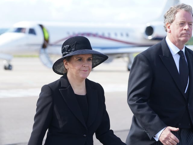 Scottish Secretary Alister Jack and First Minister of Scotland Nicola Sturgeon leave Edinburgh Airport after the arrival of King Charles III and the Queen Consort, who will join other members of the royal family for the procession of Queen Elizabeth's coffin from the Palace of Holyroodhouse to St Giles' Cathedral, Edinburgh. Picture date: Monday September 12, 2022.