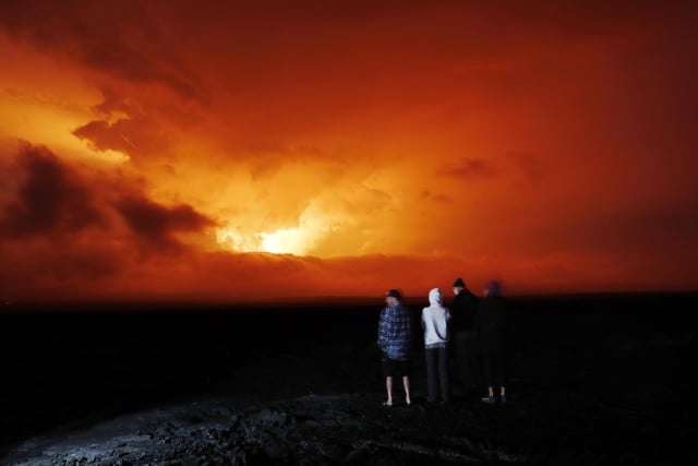People watch the eruption of Mauna Loa