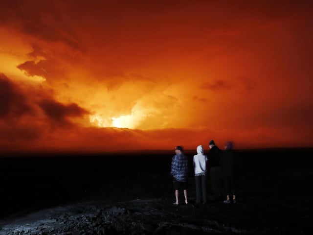 People watch the eruption of Mauna Loa