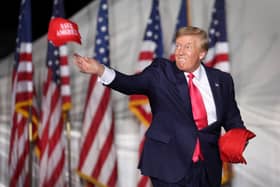 Donald Trump tosses hats to supporters during a rally in August this year in Waukesha, Wisconsin (Picture: Scott Olson/Getty Images)