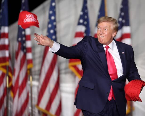 Donald Trump tosses hats to supporters during a rally in August this year in Waukesha, Wisconsin (Picture: Scott Olson/Getty Images)