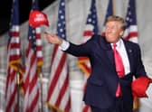 Donald Trump tosses hats to supporters during a rally in August this year in Waukesha, Wisconsin (Picture: Scott Olson/Getty Images)