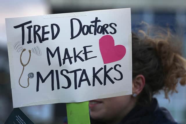 A placard makes a point as junior doctors protest about working conditions (Picture: Christopher Furlong/Getty Images)