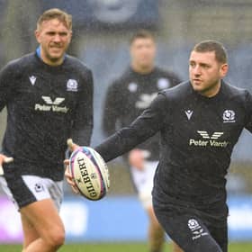 Finn Russell gets a feel of the ball during the Scotland team run at a rainy Murrayfield ahead of the Argentina match, with Chris Harris on the left. (Photo by Ross MacDonald / SNS Group)