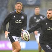 Finn Russell gets a feel of the ball during the Scotland team run at a rainy Murrayfield ahead of the Argentina match, with Chris Harris on the left. (Photo by Ross MacDonald / SNS Group)