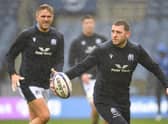 Finn Russell gets a feel of the ball during the Scotland team run at a rainy Murrayfield ahead of the Argentina match, with Chris Harris on the left. (Photo by Ross MacDonald / SNS Group)