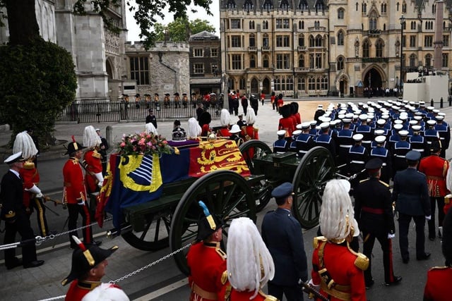 The coffin of Queen Elizabeth II, draped in the Royal Standard, arrives at Westminster Abbey in London on September 19, 2022, for the State Funeral Service for Britain's Queen Elizabeth II. - Leaders from around the world will attend the state funeral of Queen Elizabeth II. The country's longest-serving monarch, who died aged 96 after 70 years on the throne, will be honoured with a state funeral on Monday morning at Westminster Abbey. (Photo by Marco BERTORELLO / AFP) (Photo by MARCO BERTORELLO/AFP via Getty Images)