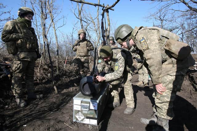 Servicemen of Ukrainian Military Forces on the front-line with Russia-backed separatists near Novognativka village, Donetsk region, examine a Swedish-British portable anti-tank guided missile NLAW that was transferred to the units as part of Britain's military-technical assistance, on February 21, 2022. Photo by Anatolii Stepanov AFP/Getty