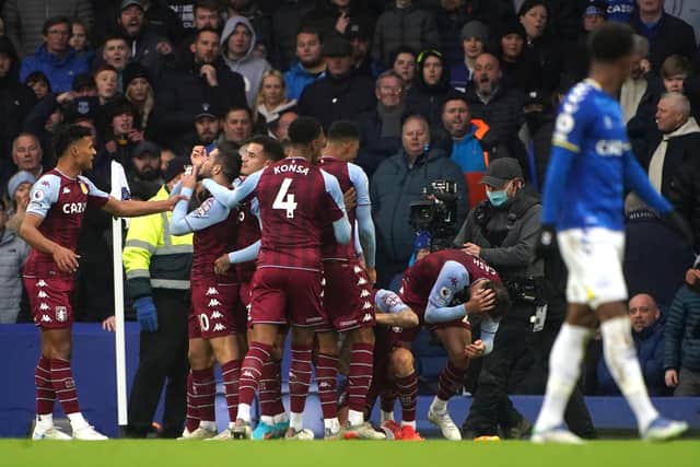 Aston Villa's Matty Cash (second right) is hit with a bottle while celebrating the goal of team-mate Emiliano Buendia during the Premier League match at Goodison Park Park, Liverpool. Picture date: Saturday January 22, 2022. PA Photo. See PA story SOCCER Everton. Photo credit should read: Peter Byrne/PA Wire.RESTRICTIONS: EDITORIAL USE ONLY No use with unauthorised audio, video, data, fixture lists, club/league logos or "live" services. Online in-match use limited to 120 images, no video emulation. No use in betting, games or single club/league/player publications.