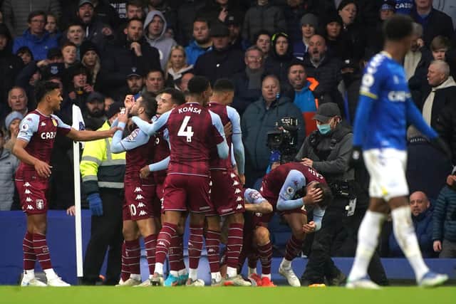 Aston Villa's Matty Cash (second right) is hit with a bottle while celebrating the goal of team-mate Emiliano Buendia during the Premier League match at Goodison Park Park, Liverpool. Picture date: Saturday January 22, 2022. PA Photo. See PA story SOCCER Everton. Photo credit should read: Peter Byrne/PA Wire.
RESTRICTIONS: EDITORIAL USE ONLY No use with unauthorised audio, video, data, fixture lists, club/league logos or "live" services. Online in-match use limited to 120 images, no video emulation. No use in betting, games or single club/league/player publications.