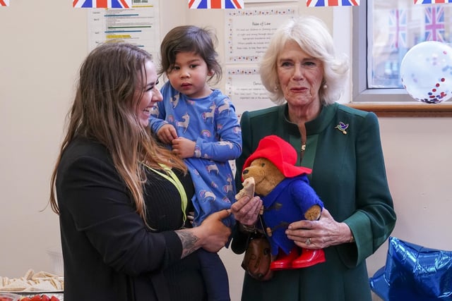 To mark the end of her visit, the Queen Consort shared marmalade sandwiches seated beside Mr Bonneville, Ms Harris and Ms Jankel, while around 40 children sat cross-legged at their feet.