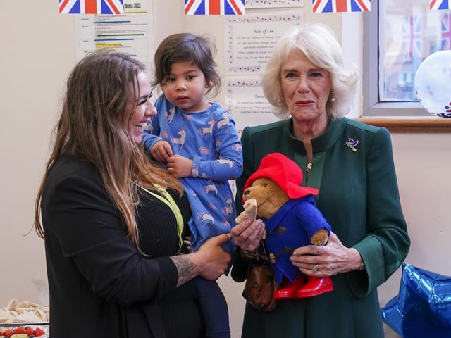 To mark the end of her visit, the Queen Consort shared marmalade sandwiches seated beside Mr Bonneville, Ms Harris and Ms Jankel, while around 40 children sat cross-legged at their feet.