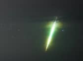 A fisherman watches a meteor during the Draconid meteor shower over Howick rocks in Northumberland.
