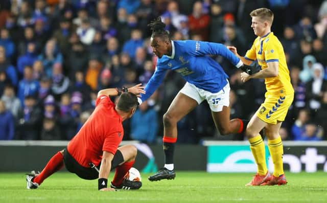 Croatian referee Fran Jovic is sent sprawling as he tries to get out of the way of rampaging Rangers midfielder Joe Aribo at Ibrox. (Photo by Craig Williamson / SNS Group)