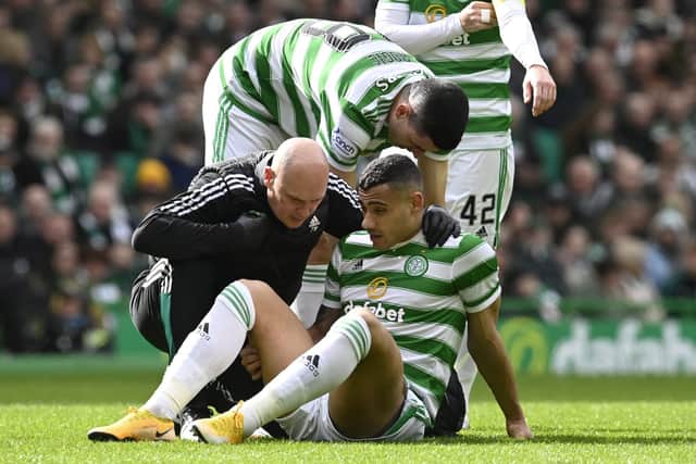 Celtic's Giorgos Giakoumakis goes down injured against St Johnstone.