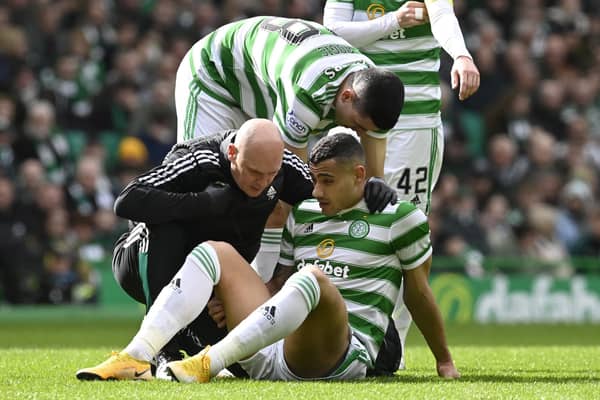 Celtic's Giorgos Giakoumakis goes down injured against St Johnstone.