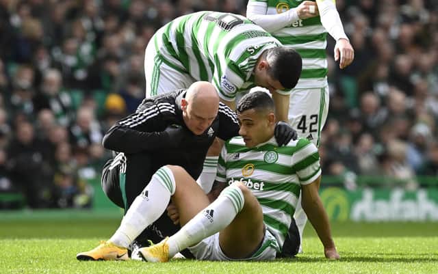 Celtic's Giorgos Giakoumakis goes down injured against St Johnstone.