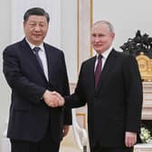 In this photo released by Xinhua News Agency, Chinese President Xi Jinping, left, shakes hands with Russian President Vladimir Putin prior to their talks at the Kremlin in Moscow on Monday, March 20, 2023.   (Shen Hong/Xinhua via AP)