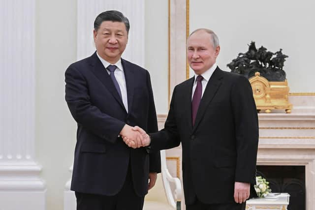 In this photo released by Xinhua News Agency, Chinese President Xi Jinping, left, shakes hands with Russian President Vladimir Putin prior to their talks at the Kremlin in Moscow on Monday, March 20, 2023.   (Shen Hong/Xinhua via AP)