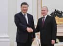 In this photo released by Xinhua News Agency, Chinese President Xi Jinping, left, shakes hands with Russian President Vladimir Putin prior to their talks at the Kremlin in Moscow on Monday, March 20, 2023.   (Shen Hong/Xinhua via AP)