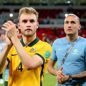 Nathaniel Atkinson of Australia celebrates after their sides victory during the 2022 FIFA World Cup Playoff match between United Arab Emirates and Australia at Ahmad Bin Ali Stadium on June 07, 2022 in Doha, Qatar. (Photo by Mohamed Farag/Getty Images)
