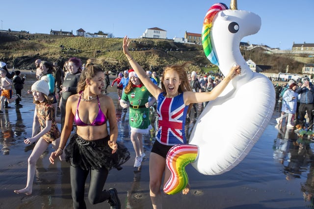 Over one hundred people take part in the Kinghorn Loony Dook New Years Day swim on the Fife coast of the Firth of Forth