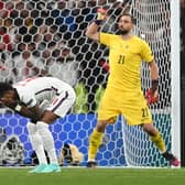 England forward Marcus Rashford reacts after missing his penalty during the Euro 2020 shoot-out defeat to Italy (Photo by ANDY RAIN/POOL/AFP via Getty Images)