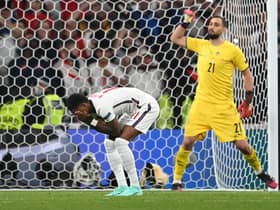 England forward Marcus Rashford reacts after missing his penalty during the Euro 2020 shoot-out defeat to Italy (Photo by ANDY RAIN/POOL/AFP via Getty Images)
