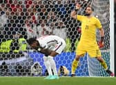 England forward Marcus Rashford reacts after missing his penalty during the Euro 2020 shoot-out defeat to Italy (Photo by ANDY RAIN/POOL/AFP via Getty Images)