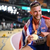 Edinburgh's Josh Kerr celebrates with his gold medal after winning the men's 1500m final at World Athletics Championships in Budapest. (Photo by KIRILL KUDRYAVTSEV/AFP via Getty Images)