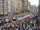 The hearse carrying the coffin of Queen Elizabeth II, draped with the Royal Standard of Scotland, passes down the Royal Mile, Edinburgh, on the journey from Balmoral to the Palace of Holyroodhouse