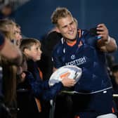 Edinburgh's Duhan Van Der Merwe takes a selfie with the fans during a United Rugby Championship match between Edinburgh and Bennetton at the DAM Health Stadium.