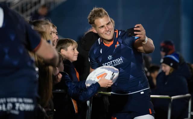 Edinburgh's Duhan Van Der Merwe takes a selfie with the fans during a United Rugby Championship match between Edinburgh and Bennetton at the DAM Health Stadium.