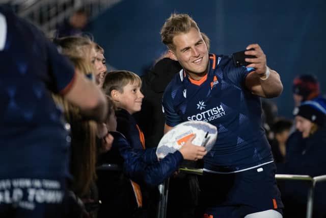 Edinburgh's Duhan Van Der Merwe takes a selfie with the fans during a United Rugby Championship match between Edinburgh and Bennetton at the DAM Health Stadium.